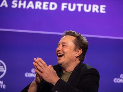 Elon Musk laughing on stage