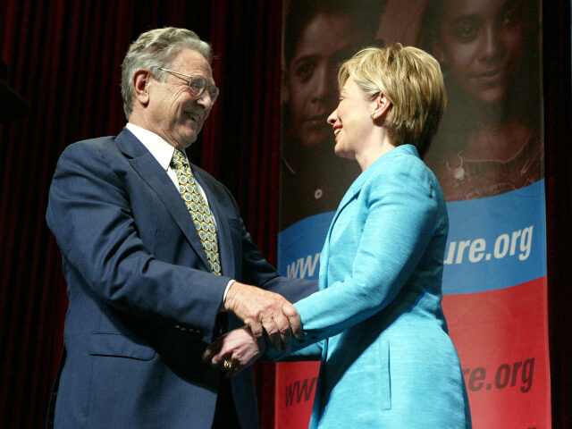 Philanthropist George Soros (L) greets U.S. Senator Hillary Clinton (D-NY) after she intro