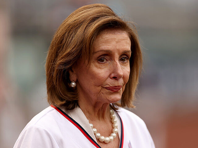 Rep. Nancy Pelosi (D-CA) looks on before throwing out the ceremonial first pitch before th