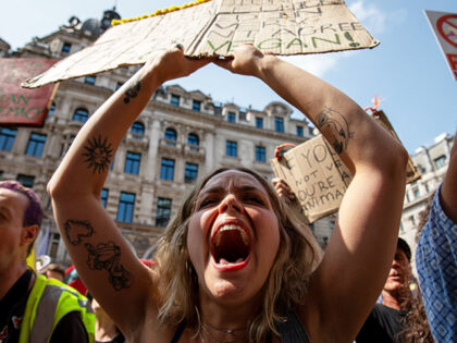 An animal rights demonstrator holds a placard during the demonstration. Thousands gathered