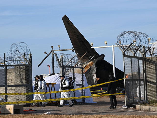 Recovery teams work at the scene where a Jeju Air Boeing 737-800 series aircraft crashed a