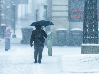 An individual walks through the snow in Lexington Sunday, Jan. 5, 2025, as a winter storm