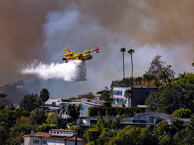 A Super SCooper plane drops water on the Palisades fire on Tuesday, Jan. 7, 2025 in Pacifi