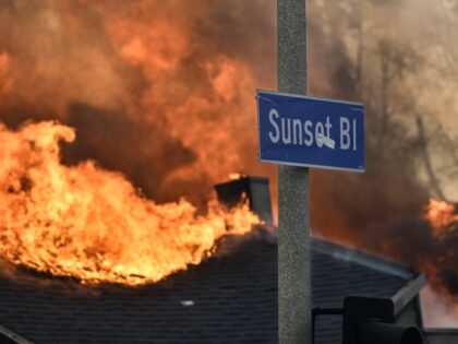 A home burns along Sunset Boulevard during the Palisades Fire on Wednesday, January 8, 202