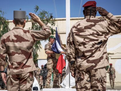 TOPSHOT - Senior military officers from the French and Chadian armed forces salute as the