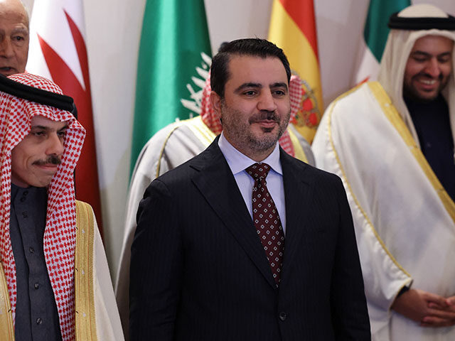 Saudi Foreign Minister Faisal bin Farhan (L) and his Syrian counterpart Asaad Al-Shaibani,