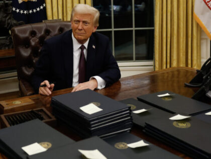 WASHINGTON, DC - JANUARY 20: President Donald Trump signs executive orders in the Oval Off