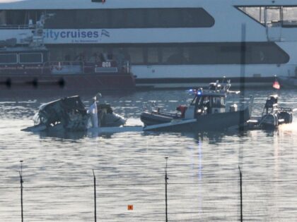 ARLINGTON, VIRGINIA - JANUARY 30: Emergency response units search the crash site of the Am