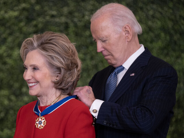 US President Joe Biden presents Hillary Clinton, former US secretary of state, with the Me