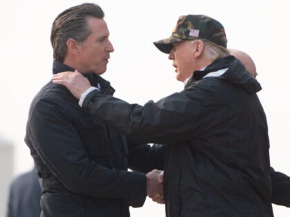 US President Donald Trump greets California Governor-elect Gavin Newsom (L) as he disembar