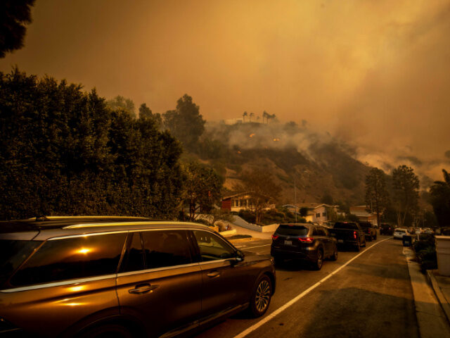 A line of vehicles crowds the road as residents flee from the Palisades Fire in the Pacifi