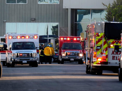 Emergency personnel respond to a commercial building where a small plane crashed on Thursd