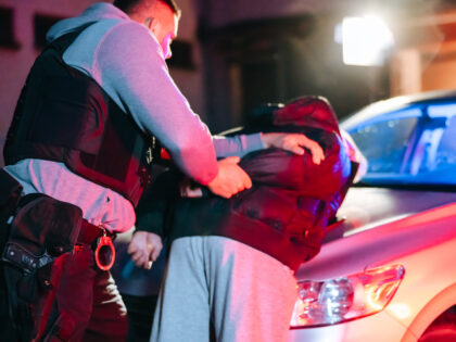 Police officer arresting man