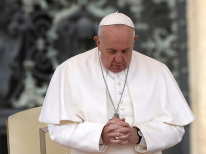 Pope Francis prays in St. Peter's Square at the Vatican during his weekly general aud