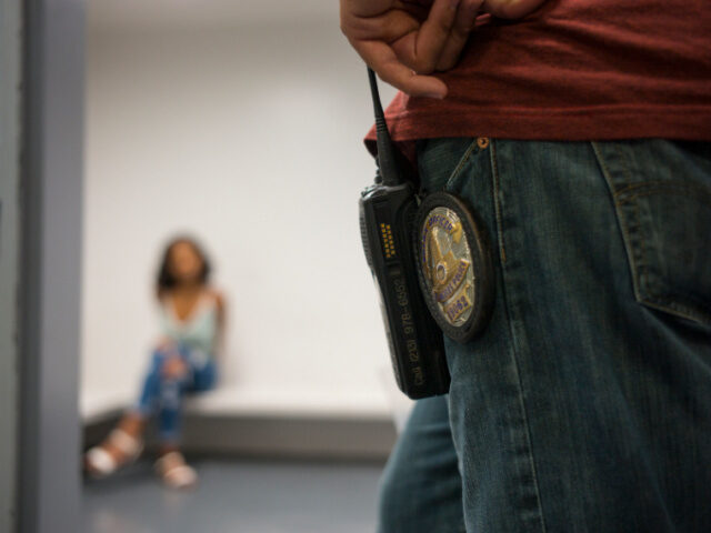 An officer of the Los Angeles Police Department's vice squad, right, monitors a 17-year ol