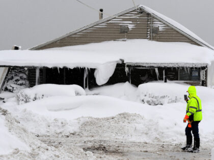 Jack Stanton checks his ice encrusted home after being battered with waves from Lake Erie