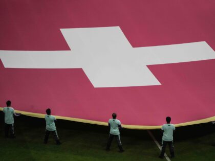 Volunteers hold a giant flag of Switzerland prior the start of the World Cup round of 16 s