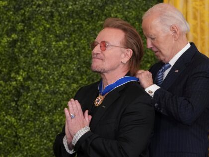 Bono receives the Medal of Freedom from United States President Joe Biden during a ceremon