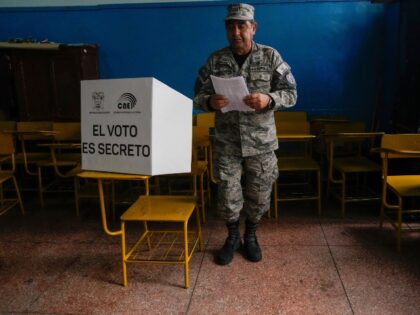 An Air Force officer votes in a referendum proposed by President Daniel Noboa to endorse n