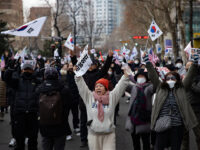 Supporters of President Yoon Suk-yeol, who is detained on charges of treason, march toward