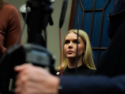 White House press secretary Karoline Leavitt watches as President Donald Trump speaks in t