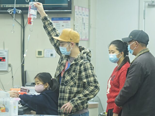 A child, accompanied by their parents, sees a doctor at a pediatric department of a hospit