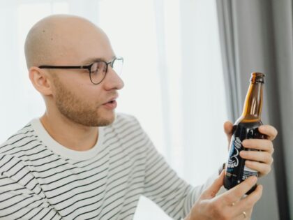 A Man Holding Beer Bottle