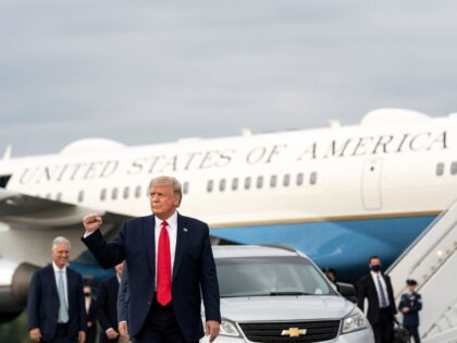 President Donald J. Trump gestures with a fist pump as he disembarks Air Force One Tuesday