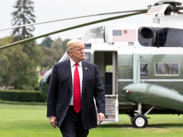 President Donald J. Trump walks across the South Lawn of the White House Sunday, March 25,