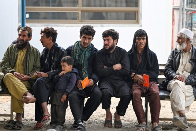 Afghan refugees returning voluntarily from Pakistan wait at the UNHCR centre in Nowshera