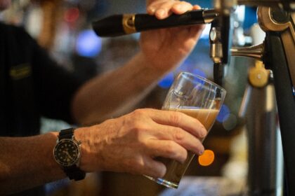 A bartender pours a draft beer in a bar in Brest, western France