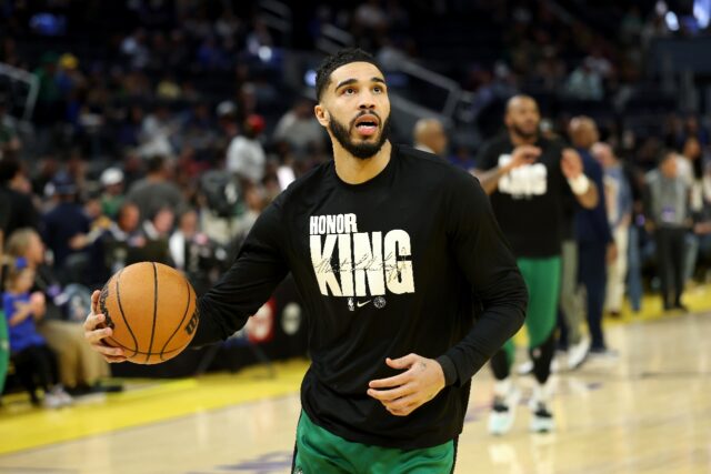 Boston's Jayson Tatum wears a shirt honoring Martin Luther King Jr. while warming up befor