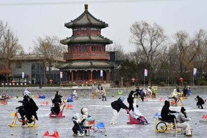 By a frozen lake dotted with ice skaters in Beijing's historic centre, people expressed op