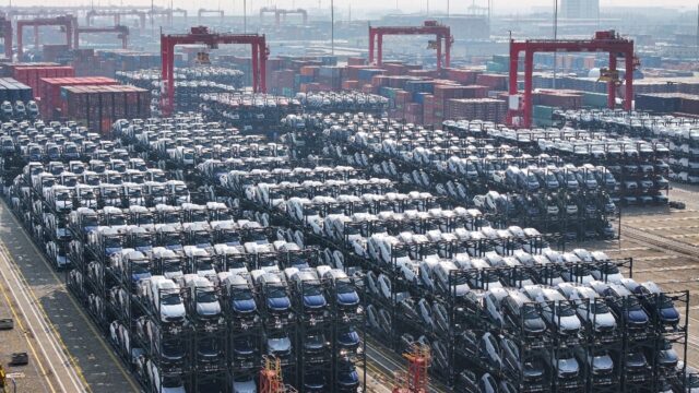 BYD electric cars waiting to be loaded onto a ship for export at the international contain