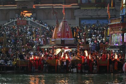 Hindu devotees gather during evening prayers at Har Ki Pauri on the banks of the Ganges Ri