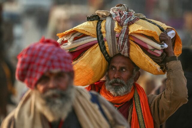 Hindu pilgrims arrive at Sangam, the confluence of Ganges, Yamuna and mythical Saraswati r