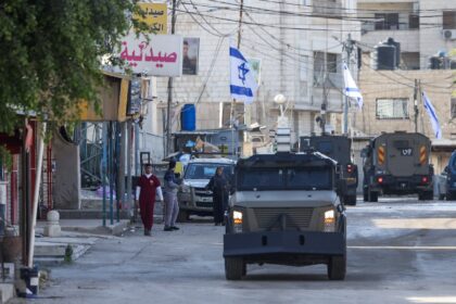 Israeli forces in armoured vehicles conduct a raid in Jenin in the occupied West Bank