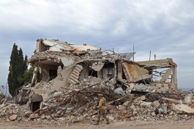A Lebansese soldier patrols a residential area in Naqura that was devastated by the war be