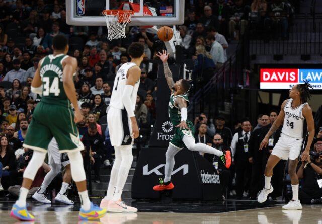Milwaukee's Damian Lillard drives to the basket as San Antonio's Victor Wembanyama looks o