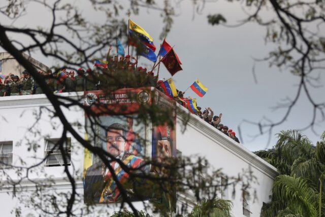 Members of the guard of honor of Venezuelan President Nicolas Maduro wave flags on the roo