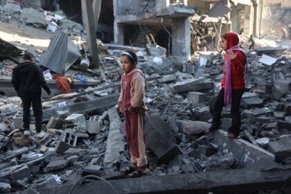 Palestinian children inspect damage after an Israeli strike in Jabalia, in the north of Ga