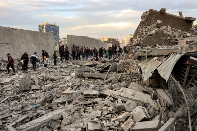 People inspect the aftermath of an Israeli strike in central Gaza over the weekend