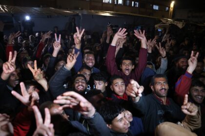 People in southern Gaza celebrate the announcement of a deal to end the 15-month war with