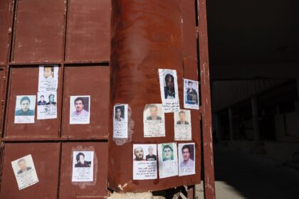 Pictures of missing people hang on the main gate of Syria's Saydnaya prison, which epitomi