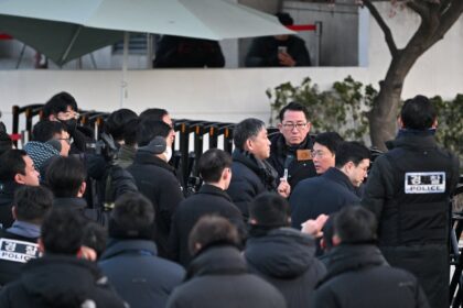 Police and anti-corruption investigators arrive at the residence of South Korea's impeache