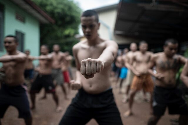 More than a hundred shaven-headed men take part in a day of weightlifting, karate drills,