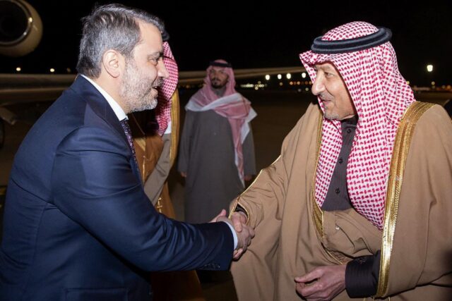 Syrian Foreign Minister Assaad al-Shibani (L) is welcomed to Saudi Arabia on his transitio