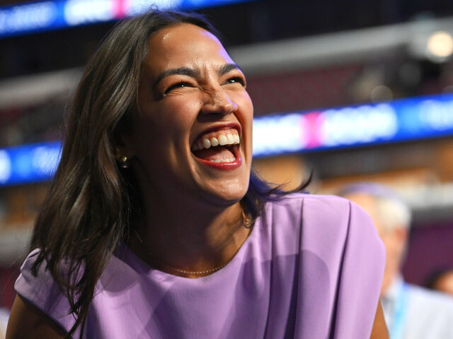 Rep. Alexandria Ocasio-Cortez (D-NY) has a laugh while on the floor of United Center ahead