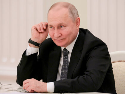 Russian President Vladimir Putin listens to Cuba's Prime Minister Manuel Marrero Cruz and