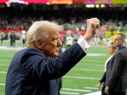 President Donald Trump gestures to the crowd before the start of the NFL Super Bowl 59 foo